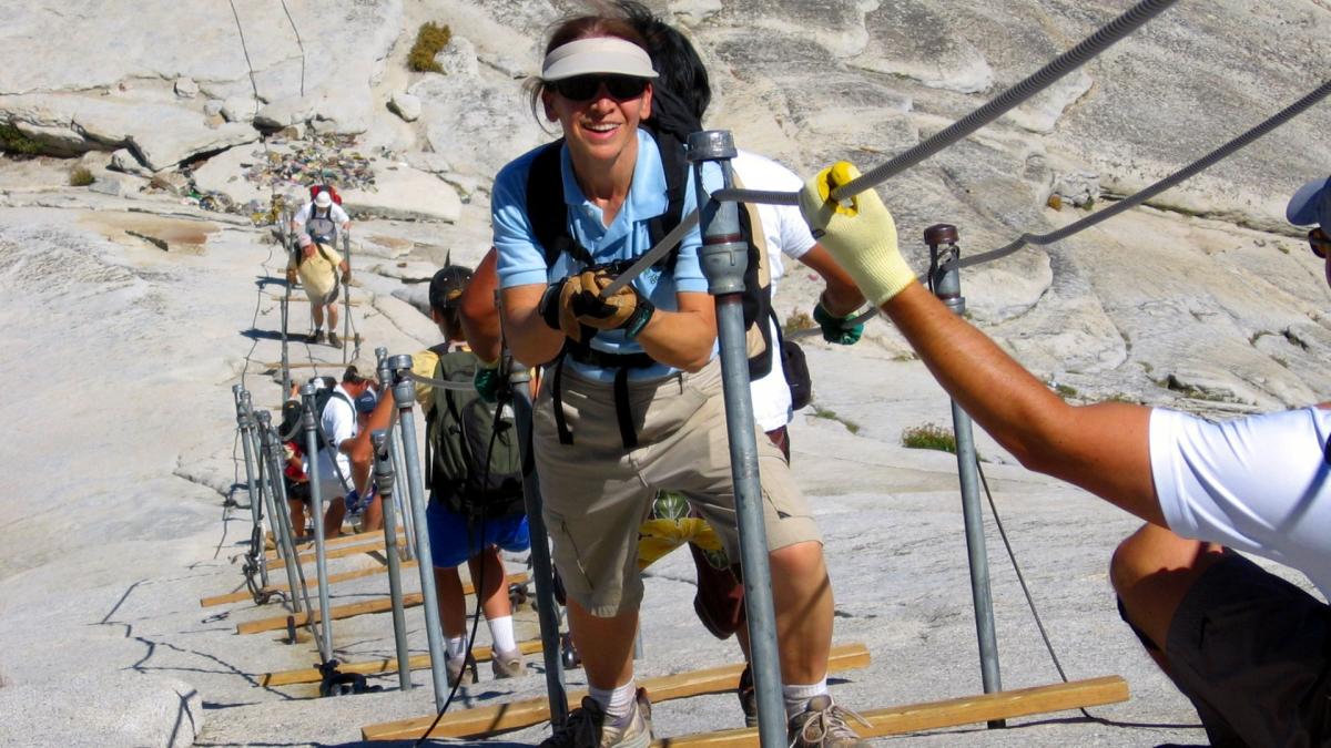 Hikers ascending Half Dome cables